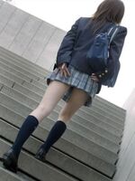 JK street image of panchira prevention holding down a short skirt