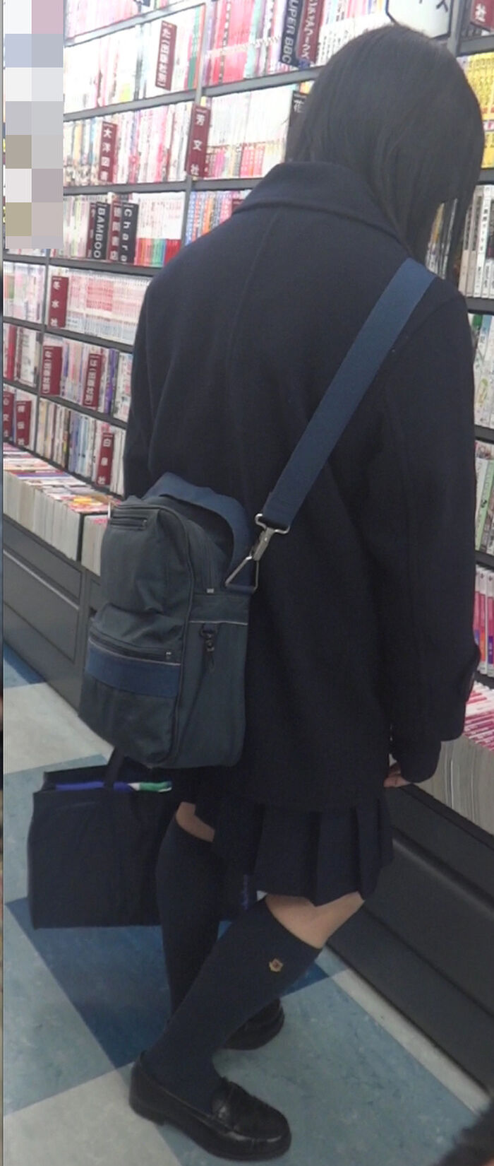 Low-angle image of JK standing reading at a bookstore 27th image