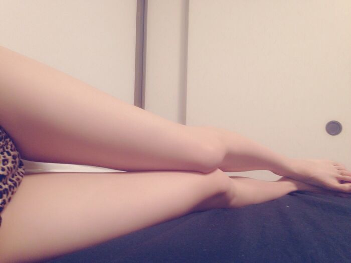 Beautiful leg slender lying on bed in leopard print pants takes a selfie 11th image