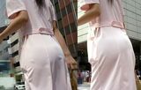 Erotic image of the back view of the shopping nurse's white coat showing through the pants