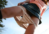 Erotic image of pulling down pants while wearing a skirt