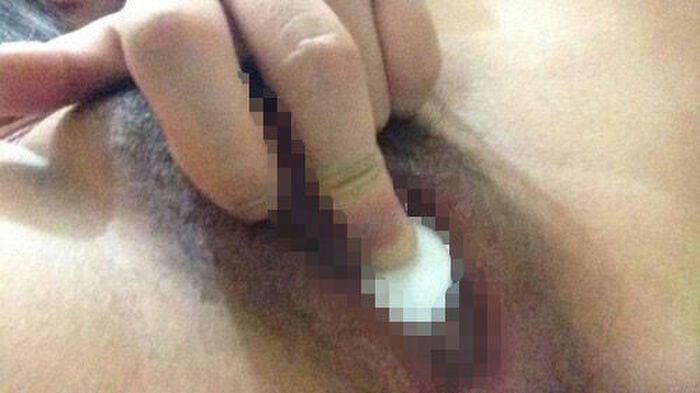 Erotic image of an amateur girl inserting a foreign object in a selfie 10th image