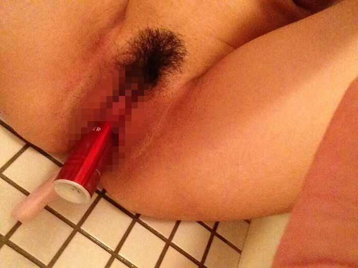 Erotic image of an amateur girl inserting a foreign object in a selfie 12th image