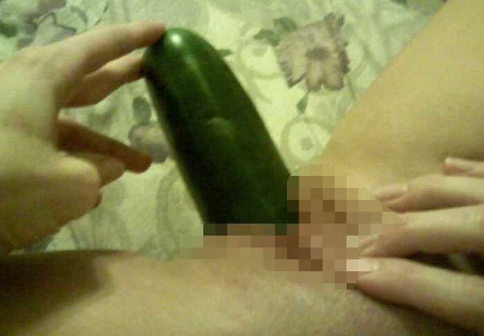 Erotic image of an amateur girl inserting a foreign object in a selfie 18th image