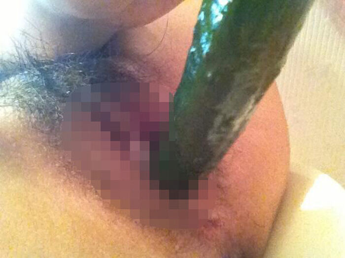 Erotic image of an amateur girl inserting a foreign object in a selfie 19th image