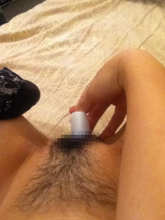 Erotic image of an amateur girl inserting a foreign object in a selfie 20th image