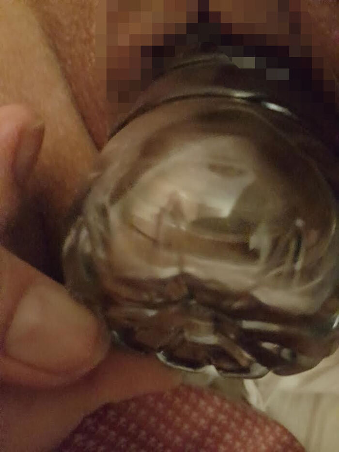 Erotic image of an amateur girl inserting a foreign object in a selfie 21th image