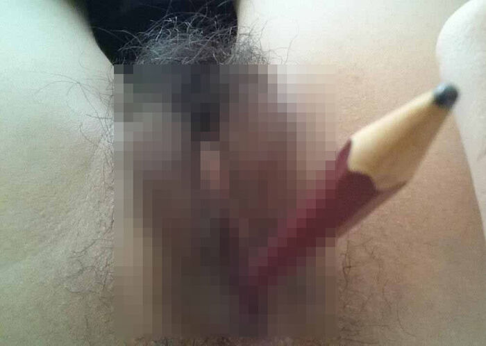 Erotic image of an amateur girl inserting a foreign object in a selfie 25th image