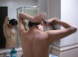 There is a nape! Erotic image of a close-up woman tying her hair in a bun before taking a bath