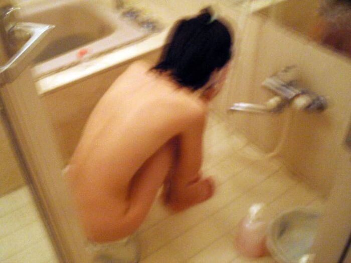 Voyeur of a girl's erotic nakedness from the gap in the window in the bath of a private house 10th image