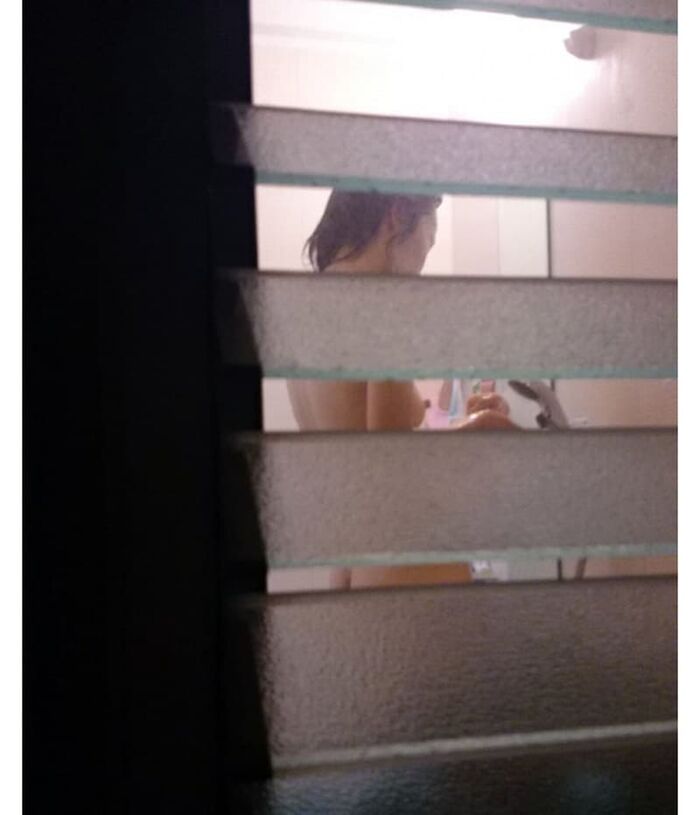 Voyeur of a girl's erotic nakedness from the gap in the window in the bath of a private house 17th image