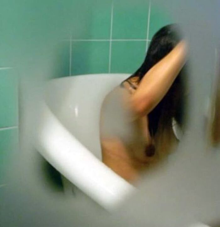 Voyeur of a girl's erotic nakedness from the gap in the window in the bath of a private house 20th image