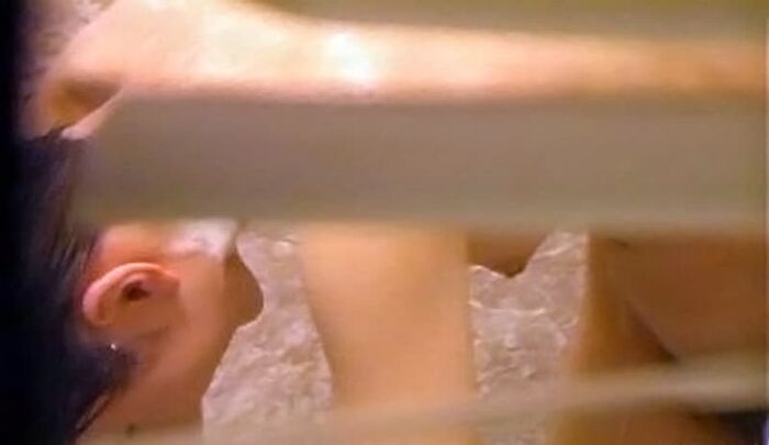 Voyeur of a girl's erotic nakedness from the gap in the window in the bath of a private house 26th image