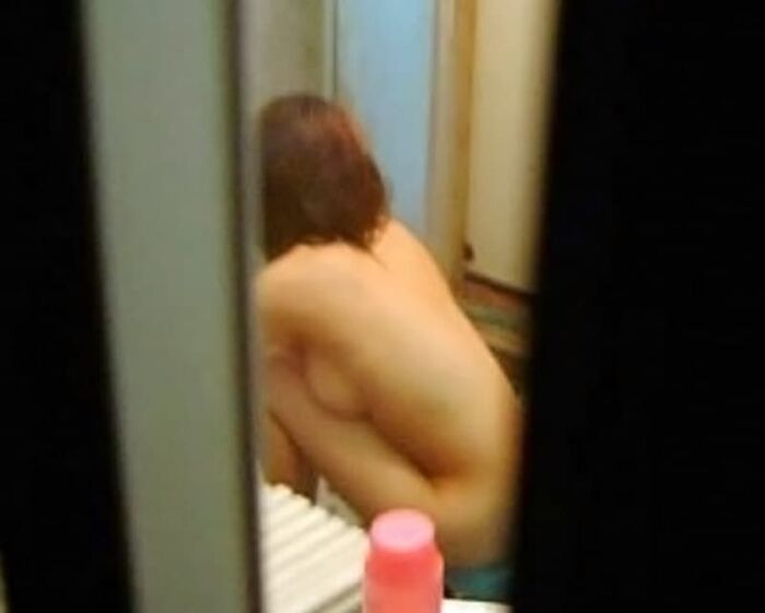Voyeur of a girl's erotic nakedness from the gap in the window in the bath of a private house 30th image