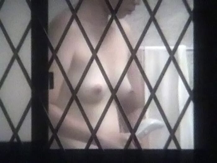 Voyeur of a girl's erotic nakedness from the gap in the window in the bath of a private house 33th image