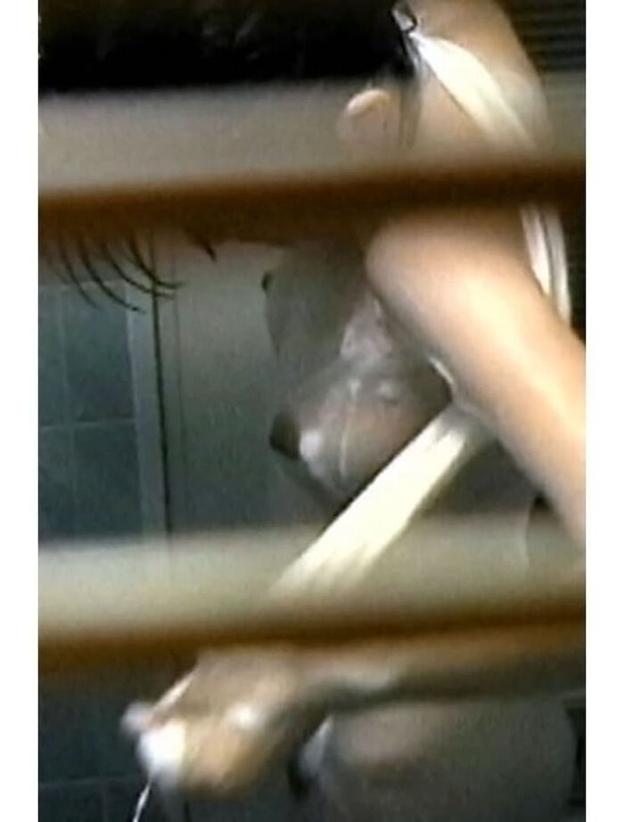 Voyeur of a girl's erotic nakedness from the gap in the window in the bath of a private house 4th image