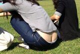 Erotic image taken in the city of a low-rise girl with a bare crack in the buttocks
